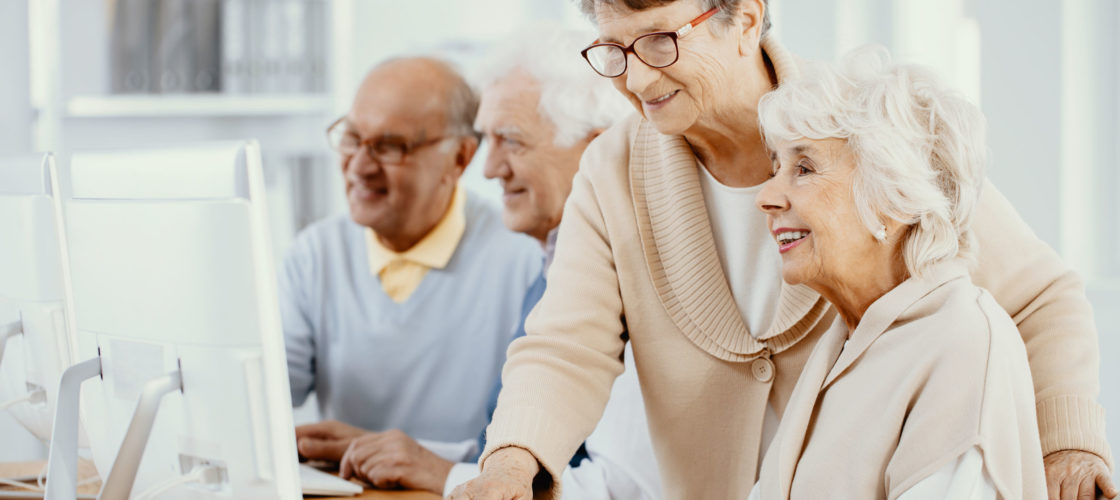 instructor helping older adults learn computer skills