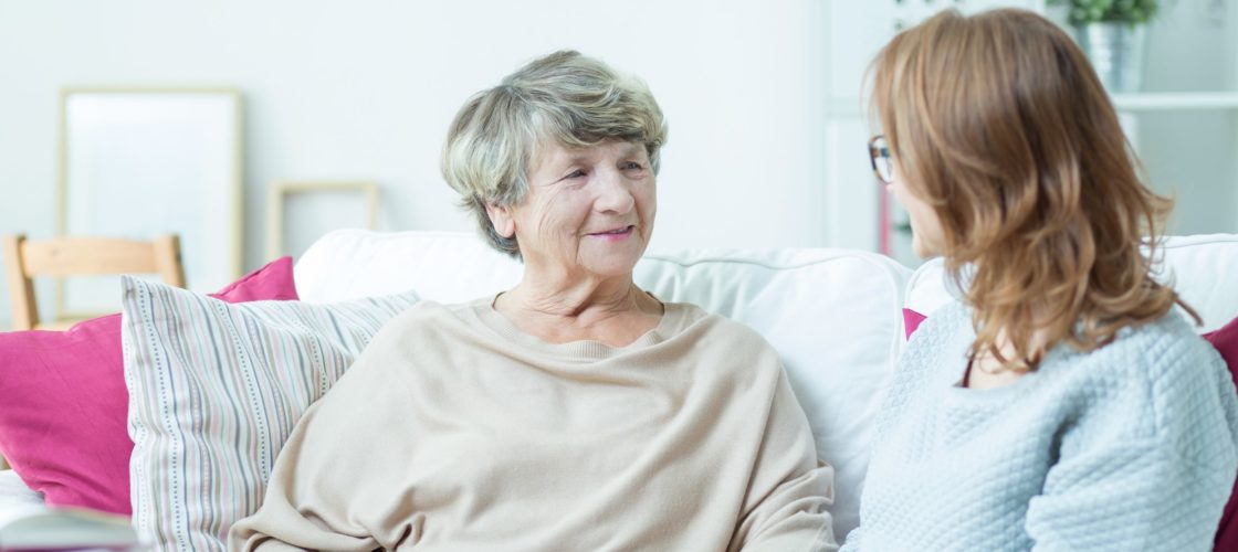 staff person talking with elderly woman